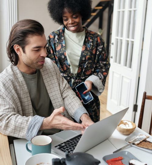 man-using-laptop-while-having-breakfast-4045924